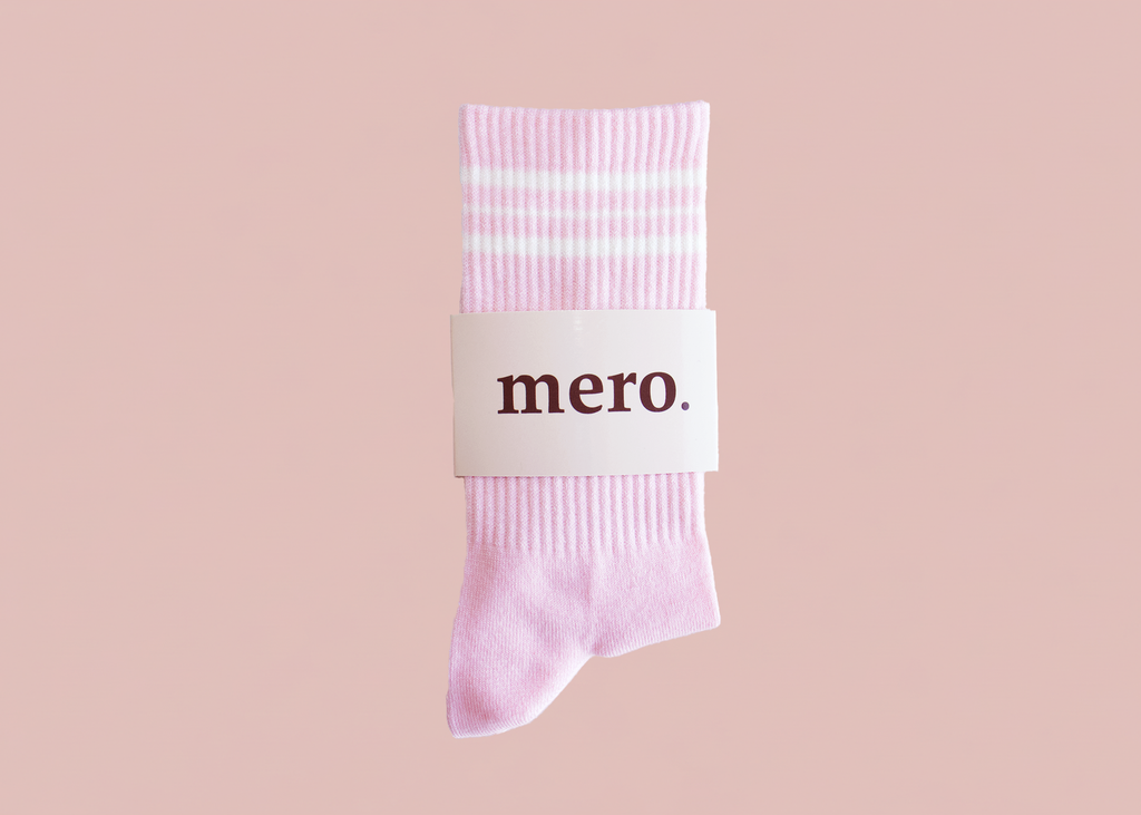 Pink sock with 'mero' label on a pink background