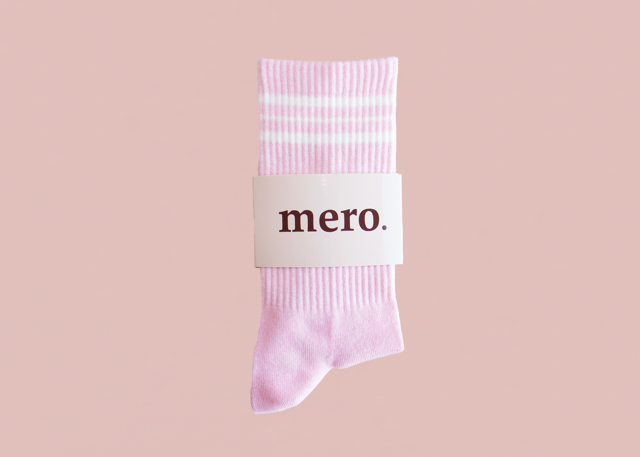Pink sock with 'mero' label on a pink background